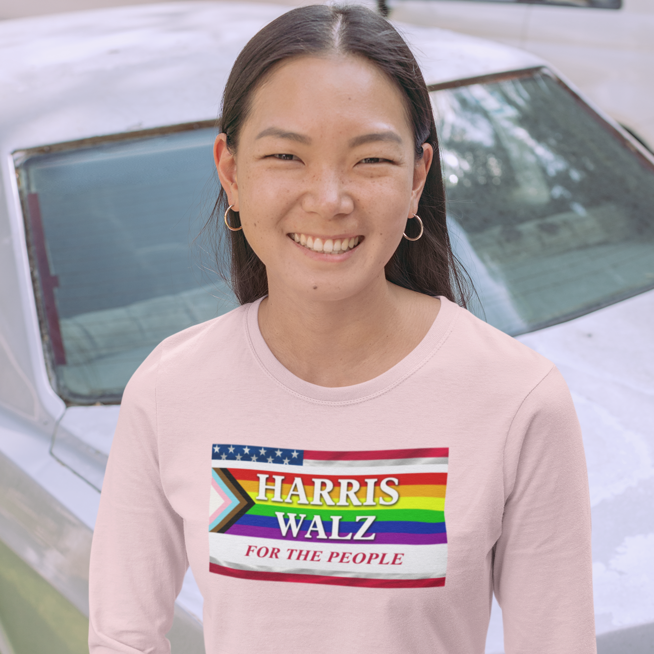 Young Asian woman wearing a pink Harris Walz for the people long sleeve t-shirt 